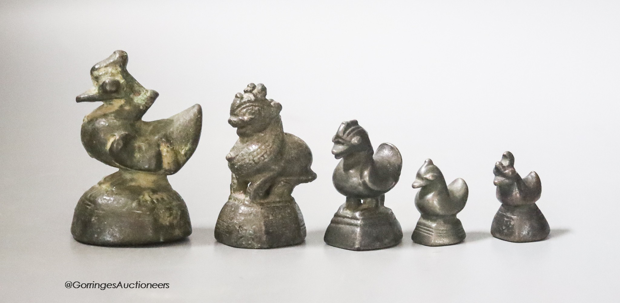 A set of five Burmese bronze opium weights, tallest 6cm